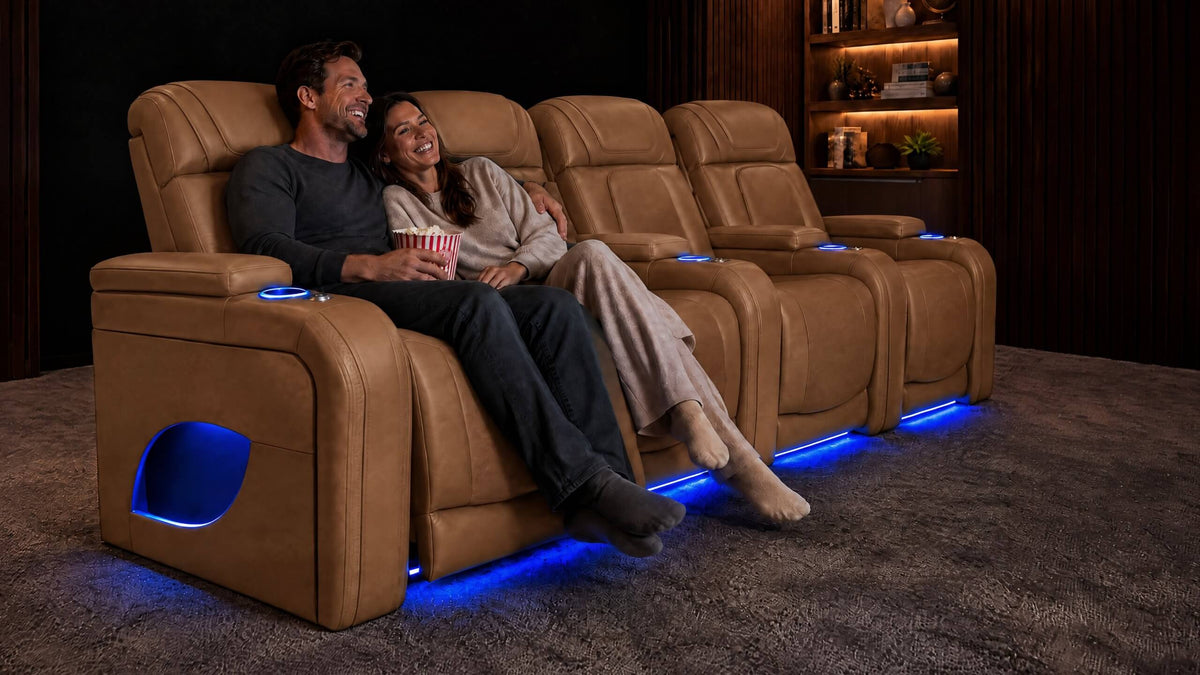 A couple relaxing in tan leather home theater recliners with blue base lighting