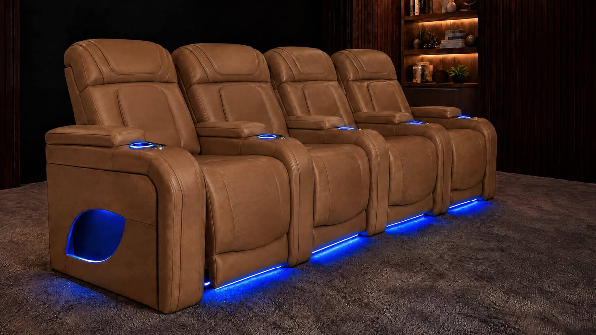 Four tan leather home theater recliners with blue base lighting in a dark theater room